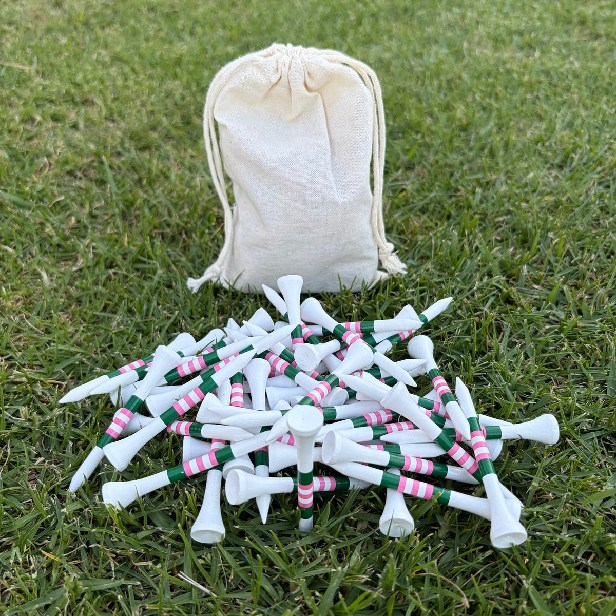 Level Pegs Tee Club Annual Pass: a pouch of white bamboo golf tees with pink and green stripes